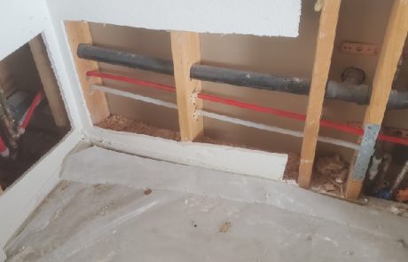 Water pipes in a wall behind plasterboard.
